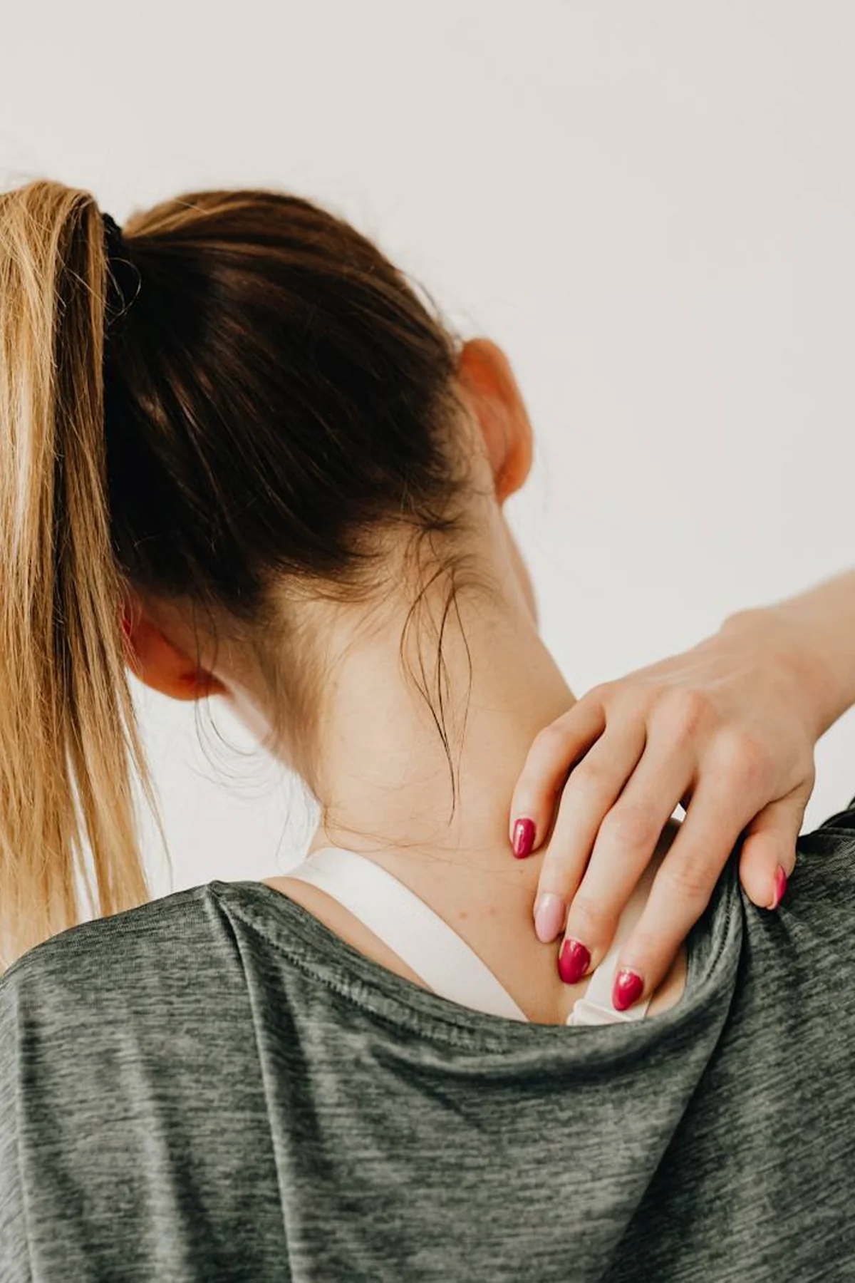Woman holding her neck, suggesting pain relief